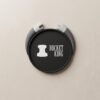 Custom 3D soft PVC coaster with a black round body and gray dimensional handles, featuring white "BUCKET KING" lettering and icon on the front, on a light beige solid-color background