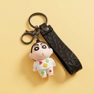 Custom 3D PVC Keychain Classic Anime Chibi Soft PVC Figurine Charm 3D soft PVC keychain featuring a classic anime character in chibi figurine form, wearing white pajamas with red, green, and yellow geometric patterns, paired with a black textured faux leather strap and metal lobster clasp, displayed on a solid-color background