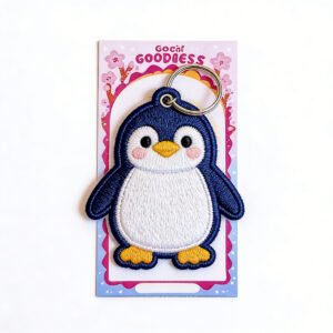 Custom Embroidered Keychains Personalized Cute Animal Designs Custom embroidered penguin keychain with blushing cheeks on a pink & blue card, perfect for gifts & party favors