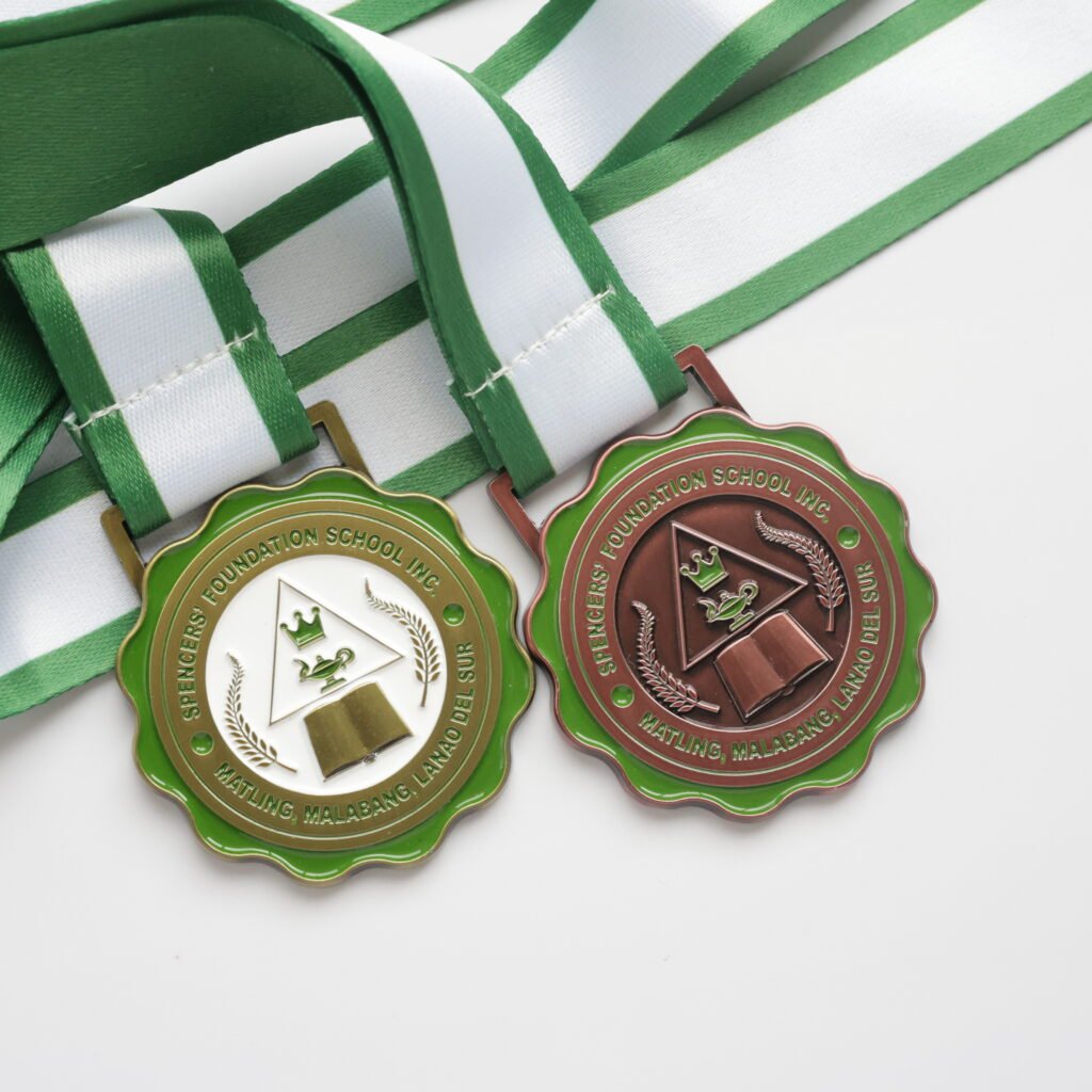Custom metal medal with a green wavy border and white/brown base, featuring an embossed crown, magic lamp, and book motif at the center, paired with a green-and-white striped polyester strap, on a pure white background