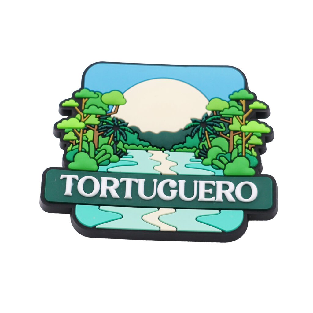 3D PVC fridge magnets featuring a tropical rainforest scene with a winding river, palm trees, and "TORTUGUERO" text on a green banner; soft rubber travel souvenir with strong magnetic backing.