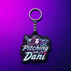 Custom printed PVC keychain featuring a female softball player with crossed bats and 'Pitching with Dani' text on purple gradient background