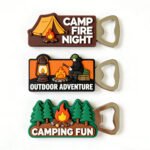 Set of three custom PVC bottle openers with camping themes: "CAMP FIRE NIGHT" tent, "OUTDOOR ADVENTURE" figure, and "CAMPING FUN" forest; features magnetic backs and silver metal opener tops.