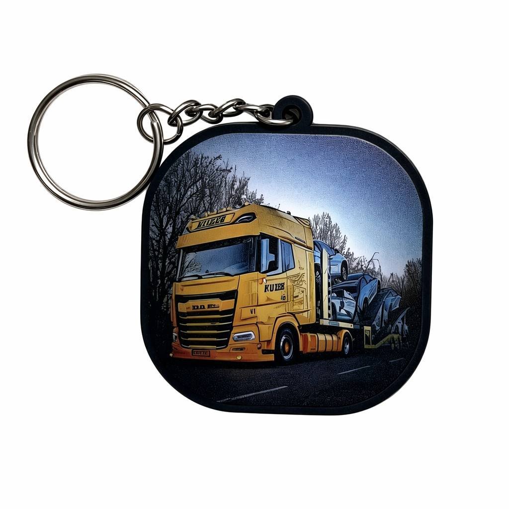 A rounded-square Customized PVC Printed Keychains with HD UV-printed yellow DAF truck hauling a sports car, attached to a double-layer metal chain and nickel-plated split ring.