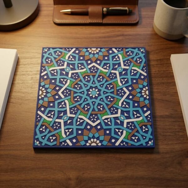 Square PVC soft rubber coaster in deep navy blue, featuring an intricate Moroccan-style geometric mosaic pattern with interwoven teal, brown, and green lines. Displayed against a pure white background.