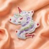 Whimsical unicorn flip sequin embroidered patch with reversible rainbow-to-silver sequins and red star accents, cursive "Dreamy" script detailing, designed for kids' clothing and backpack DIY customization, on plain white background.