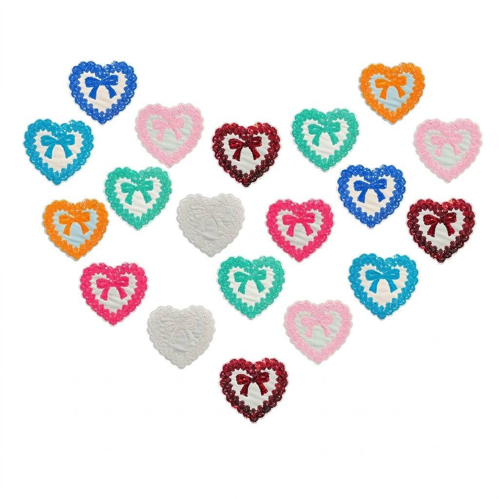 Custom reversible sequin patch featuring a pink bow and a silver heart; sequins flip to change color; framed with high-density embroidery; backed with hook-and-loop tape for DIY clothing, bag, and accessory decoration.