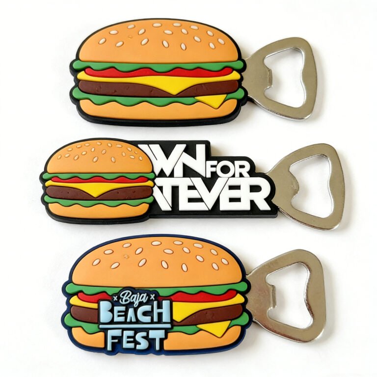 Creative soft PVC bottle opener in a multi-layer 3D hamburger design, with "WN FOR TEVER" and "Baja BEACH FEST" custom text on the filling, equipped with a metal opener head and magnetic backing, displayed on a pure white background
