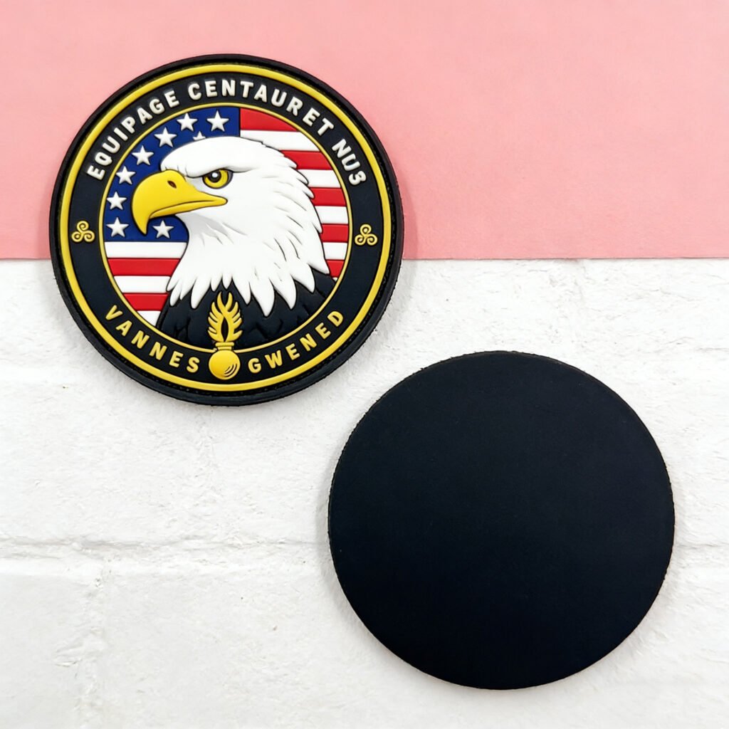 Custom bald eagle head and US flag PVC tactical patch; realistic raptor portrait set against an American flag backdrop with gold lettering and a winged torch; red, white, black, and gold color scheme; backed with hook-and-loop for tactical gear and apparel.
