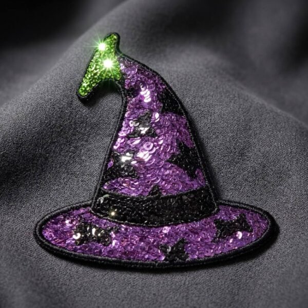 Custom sequin embroidered Velcro patch featuring a Halloween witch hat design with a purple-to-black gradient sequin finish and shimmering green tip, fully backed with Velcro, displayed against a dark gray fabric background
