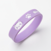 Matte purple silicone bracelet with cute white cartoon cat face, paw pad and fishbone prints; made of premium eco-friendly silicone, flexible and abrasion-resistant, suitable for daily sports wear, fashion outfit accents or exclusive pet lover souvenirs.