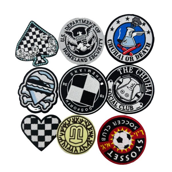 A collection of nine custom flat embroidery patches. Designs include an Ace of Spades playing card, a vintage eagle crest, "THE CHUHAI OFFICIAL CLUB" text logo, "L.I. SOCCER CLUB" badge, "GOSFORTH OWEMIANS" racing flag emblem, a flask and racket academic society logo, a light blue helmet with crossed bones, a red and black checkered heart, and a cartoon hamburger. All patches feature tightly stitched merrowed edges.