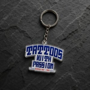 Creative T-shirt shaped acrylic keychain featuring bold vintage blue "TATTOOS WITH PASSION" lettering and red "BAYSIDE INK" branding at the base; crafted with HD UV printing and clear edge sealing for lightweight durability, ideal for daily key organization or promotional souvenirs for streetwear brands and tattoo studios.