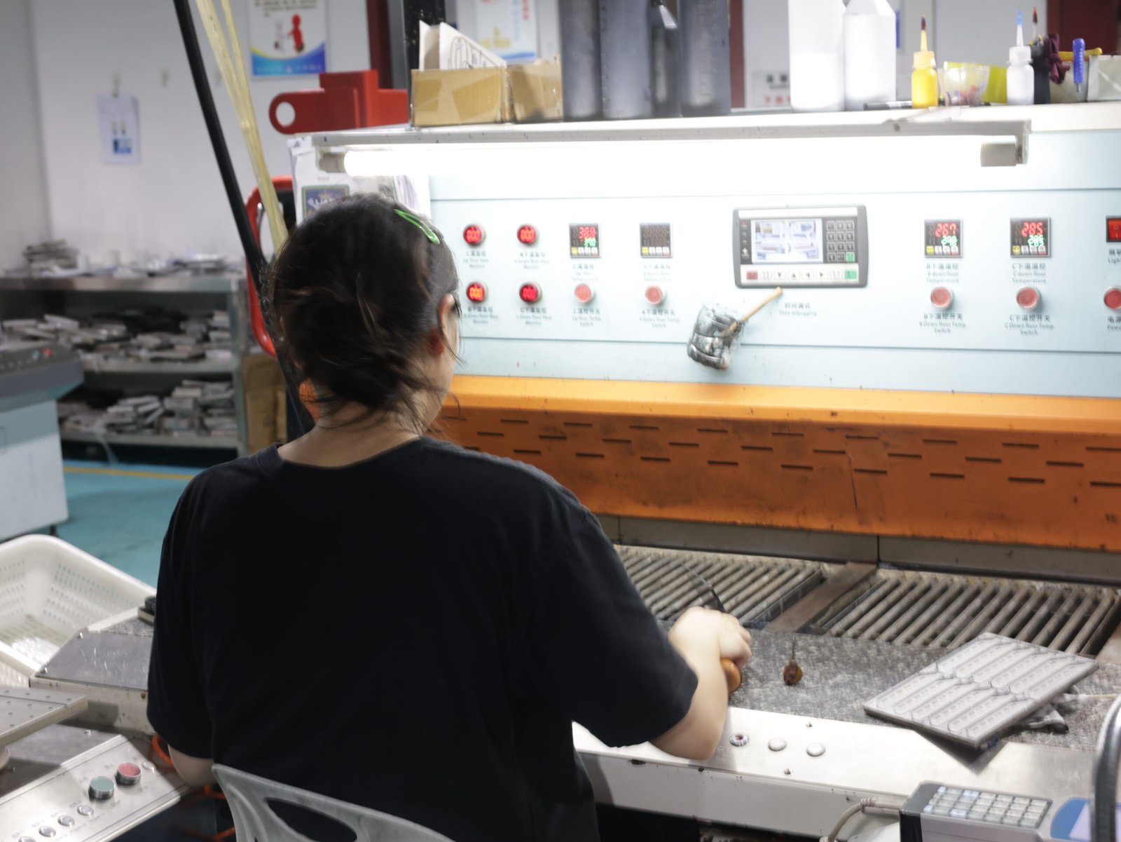 Factory operator working at a heat press machine