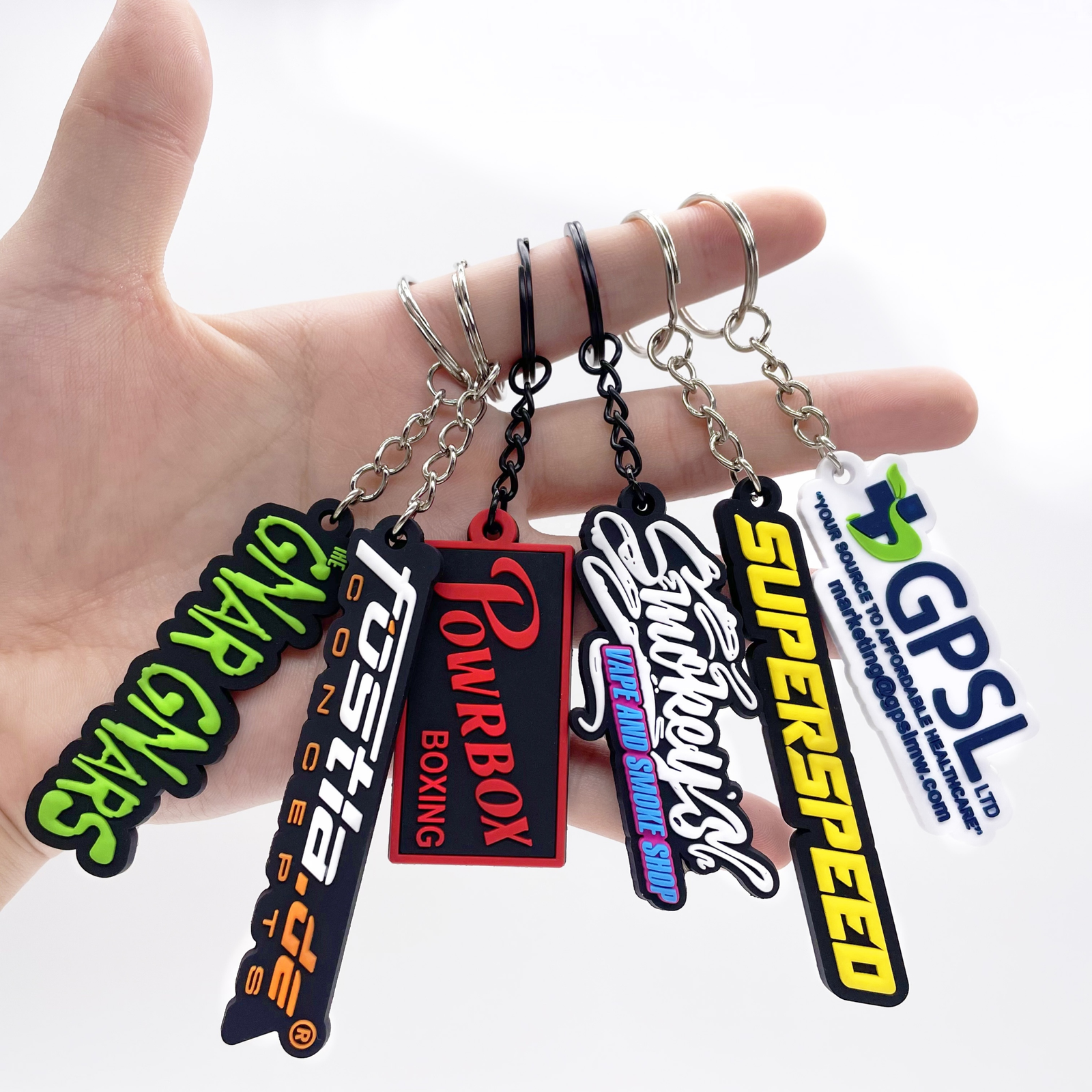 Custom 2D soft PVC logo keychains with raised lettering, short chains and metal split rings